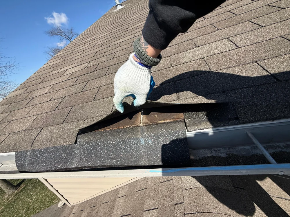 Storm damaged asphalt shingles with granule loss and broken seals that were not visible from the ground