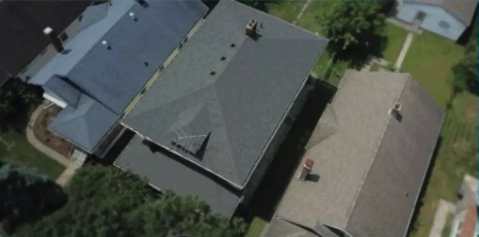 three homes from drone with shingle roofs
