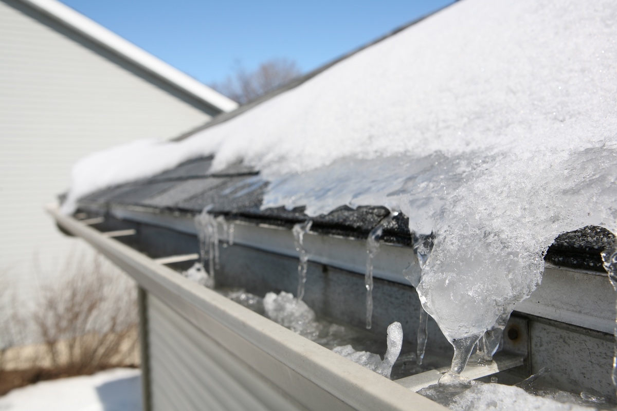 Snow and ice fill gutter system on house